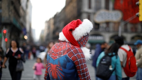 A man in a Spider-man costume is seen wearing a Santa Claus hat ahead of Christmas at Zocalo Square in Mexico City, on December 23.&nbsp;(Raquel Cunha / Reuters)