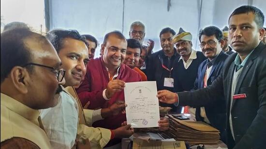 BJP candidate Akash Saxena receives his election certificate in Rampur. (FILE PHOTO)