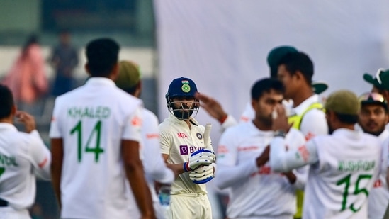 India's Virat Kohli (C) reacts after his dismissal by Bangladesh's Mehidy Hasan Miraz during the third day of the second cricket Test match between Bangladesh and India