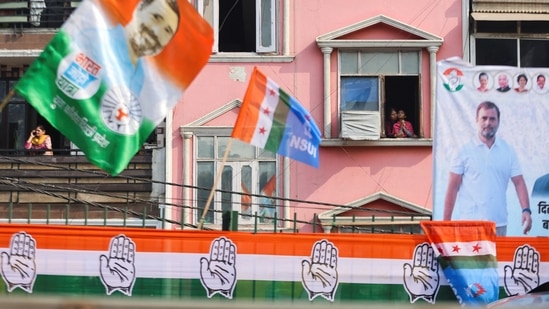 Women are seen at the window as they wait for the Bharat Jodo Yatra to pass by.(REUTERS)