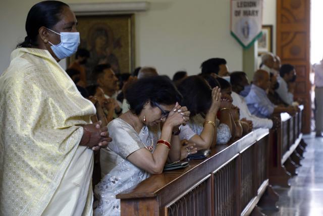 Devotees praying at a church in Pune. (Rahul Raut/HT Photo)