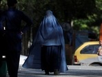 Afghanistan: An Afghan woman walks on a street in Kabul, Afghanistan.
