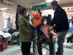 Relatives attend to a sickened patient in a wheelchair at the emergency department of the Langfang No. 4 People's Hospital in Bazhou city in northern China's Hebei province on Thursday, Dec. 22, 2022. (AP) Relatives attend to a sickened patient in a wheelchair at the emergency department of the Langfang No. 4 People's Hospital in Bazhou city in northern China's Hebei province on Thursday, Dec. 22, 2022. (AP)