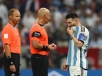 Argentina's Lionel Messi with referee Szymon Marciniak before the penalty shootout 