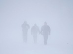 Three men walk down Richmond Avenue in whiteout conditions during a sustained blizzard in Buffalo, New York. (The Buffalo News via AP) Three men walk down Richmond Avenue in whiteout conditions during a sustained blizzard in Buffalo, New York. (The Buffalo News via AP)