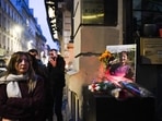 A woman looks on next to tribute flowers and a picture of Emine Kara, one of the victims of a shooting on December 23, 2022, in front of the "Centre democratique du Kurdistan" (Kurdistan democratic centre) in Paris on December 24, 2022. (Photo by Julie SEBADELHA/AFP) A woman looks on next to tribute flowers and a picture of Emine Kara, one of the victims of a shooting on December 23, 2022, in front of the "Centre democratique du Kurdistan" (Kurdistan democratic centre) in Paris on December 24, 2022. (Photo by Julie SEBADELHA/AFP)