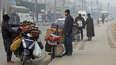 Roadside vendors sell warm clothes on the banks of the Dal Lake on a cold winter morning, in Srinagar. (ANI Photo) Roadside vendors sell warm clothes on the banks of the Dal Lake on a cold winter morning, in Srinagar. (ANI Photo)