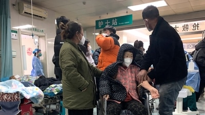 Relatives attend to a sickened patient in a wheelchair at the emergency department of the Langfang No. 4 People's Hospital in Bazhou city in northern China's Hebei province on Thursday, Dec. 22, 2022. (AP) Relatives attend to a sickened patient in a wheelchair at the emergency department of the Langfang No. 4 People's Hospital in Bazhou city in northern China's Hebei province on Thursday, Dec. 22, 2022. (AP)