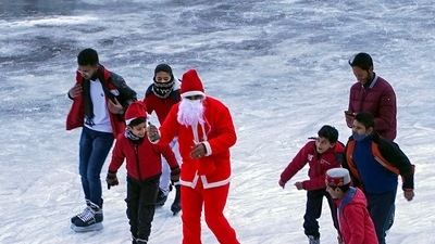A man dressed as Santa Claus on Christmas skates with other students at an ice-skating rink at Lakkar Bazar in Shimla on Sunday. (PTI) A man dressed as Santa Claus on Christmas skates with other students at an ice-skating rink at Lakkar Bazar in Shimla on Sunday. (PTI)