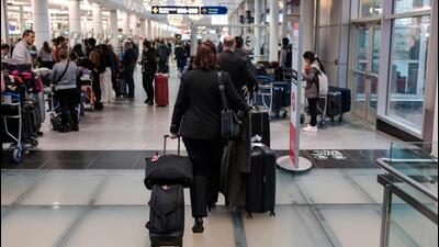 Travellers wait at the Pierre-Elliot Trudeau International Airport in Montreal, Quebec, Canada. (AFP) Travellers wait at the Pierre-Elliot Trudeau International Airport in Montreal, Quebec, Canada. (AFP)