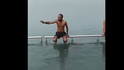 In a viral video, a man offers to take a holy dip on people's behalf amid the cold weather. (Twitter)