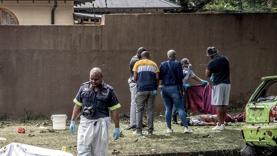 South Africa Blast: South African Police Service (SAPS) officers and forensic experts stand beside bodies in Boksburg.(AFP) South Africa Blast: South African Police Service (SAPS) officers and forensic experts stand beside bodies in Boksburg.(AFP)