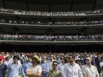Spectators stand during a tribute to late Australian cricketers Shane Spectators stand during a tribute to late Australian cricketers Shane