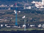 South Korea: Flags of North Korea, rear, and South Korea, front, flutter in the wind. South Korea: Flags of North Korea, rear, and South Korea, front, flutter in the wind.