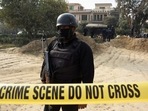 A police officer stands inside cordoned-off area after a suicide car bombing in Islamabad, Pakistan, on December 23.