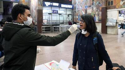 A healthcare worker collects a swab sample from a passenger at railway station in Patna on Monday. (ANI) A healthcare worker collects a swab sample from a passenger at railway station in Patna on Monday. (ANI)