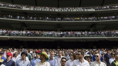 Spectators stand during a tribute to late Australian cricketers Shane (AP) Spectators stand during a tribute to late Australian cricketers Shane (AP)