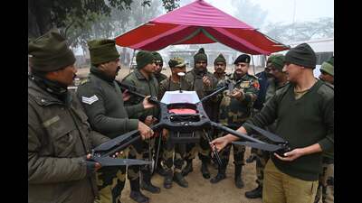 BSF personnel display a drone gunned down by the BSF troops in the vicinity of Rajatal border out post near Amritsar on Monday. (Photo by Narinder Nanu / AFP) (AFP)
