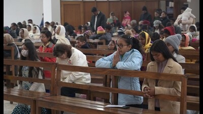 Devotees offering prayers on Christmas at Christ the King Cathedral in Sector 19, Chandigarh, on Sunday. (Keshav Singh/HT)