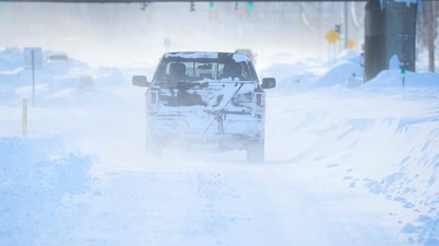 US Winter Storm: Vehicles drive through blowing snow following a winter storm. (Reuters)
