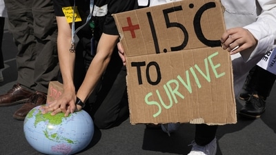 Demonstrators pretend to resuscitate the Earth while advocating for the 1.5 degree warming goal to survive at the COP27 U.N. Climate Summit. (AP file) Demonstrators pretend to resuscitate the Earth while advocating for the 1.5 degree warming goal to survive at the COP27 U.N. Climate Summit. (AP file)