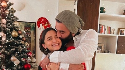 In this adorable photo, Ranbir Kapoor can be seen hugging his wife Alia Bhatt and giving her a peck on her cheeks near the Christmas tree. (Instagram/@aliaabhatt) In this adorable photo, Ranbir Kapoor can be seen hugging his wife Alia Bhatt and giving her a peck on her cheeks near the Christmas tree. (Instagram/@aliaabhatt)