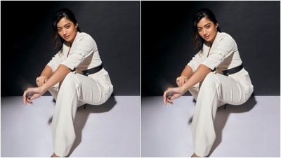 In a white wrap around coat with a black belt and a pair of white formal trousers, Rashmika rounded off her look with shiny black stilettos with pointed details. (Instagram/@rashmika_mandanna) In a white wrap around coat with a black belt and a pair of white formal trousers, Rashmika rounded off her look with shiny black stilettos with pointed details. (Instagram/@rashmika_mandanna)