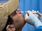 A resident receives a nasal spray vaccine as booster dose against coronavirus disease (COVID-19). REUTERS  