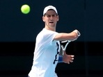 FILE PHOTO: Serbian tennis player Novak Djokovic practices on Rod Laver Arena ahead of the 2022 Australian Open at Melbourne Park, in Melbourne, Australia, January 11, 2022. 
