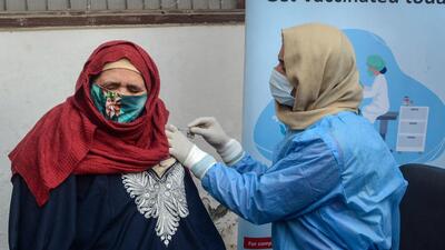 A woman gets a booster dose of the Covid-19 vaccine in Srinagar on Tuesday. (PTI) A woman gets a booster dose of the Covid-19 vaccine in Srinagar on Tuesday. (PTI)