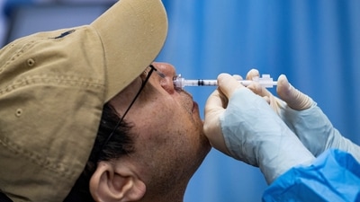 A resident receives a nasal spray vaccine as booster dose against coronavirus disease (COVID-19). REUTERS (REUTERS)