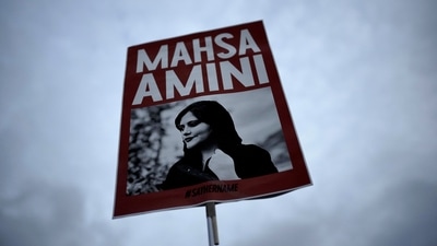 Iran Protests: A woman holds a placard with a picture of Iranian woman Mahsa Amini during a protest against her death. (AP) Iran Protests: A woman holds a placard with a picture of Iranian woman Mahsa Amini during a protest against her death. (AP)
