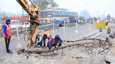 NHAI workers carrying out repair work on Dholewal flyover in Ludhiana. (Harvinder Singh/HT)