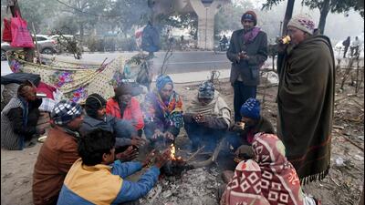 People sit around a bonfire to warm themselves on a cold winter day, at Kashmiri Gate, in New Delhi on Tuesday. (ANI) People sit around a bonfire to warm themselves on a cold winter day, at Kashmiri Gate, in New Delhi on Tuesday. (ANI)