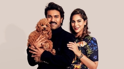 Ram Charan poses with his wife Upasana and their pet dog.
