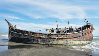 Villagers look at the boat after it docked in Aceh, Indonesia. (AFP) Villagers look at the boat after it docked in Aceh, Indonesia. (AFP)