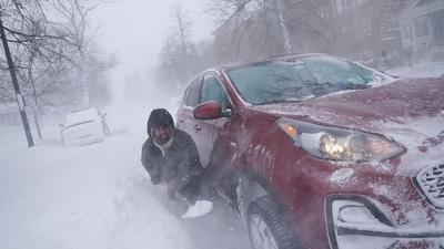 A resident of Buffalo tries to dig out his car on Lafayette Avenue after he got stuck in a snowdrift about a block from home while trying to help rescue his cousin, who had lost power and heat with a baby at home across town. (AP) A resident of Buffalo tries to dig out his car on Lafayette Avenue after he got stuck in a snowdrift about a block from home while trying to help rescue his cousin, who had lost power and heat with a baby at home across town. (AP)