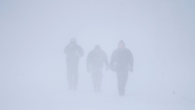 Three men walk down Richmond Avenue in whiteout conditions during a sustained blizzard in Buffalo, N.Y. on Saturday, Dec. 24, 2022. (AP) Three men walk down Richmond Avenue in whiteout conditions during a sustained blizzard in Buffalo, N.Y. on Saturday, Dec. 24, 2022. (AP)