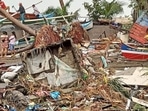 Residents survey damage caused by heavy rain and floods in Oroquieta City, Misamis Occidental, on December 27. The death toll from heavy rains and floods that devastated parts of the Philippines over the Christmas weekend has risen to 25, the national disaster response agency told AP. (Angelica Villarta / AFP)