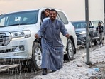 Kuwait Rain-Hailstorm: People inspect hail particles lying on the side of a road after a storm in the Umm al-Haiman district.(AFP) Kuwait Rain-Hailstorm: People inspect hail particles lying on the side of a road after a storm in the Umm al-Haiman district.(AFP)