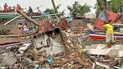 Residents survey damage caused by heavy rain and floods in Oroquieta City, Misamis Occidental, on December 27. The death toll from heavy rains and floods that devastated parts of the Philippines over the Christmas weekend has risen to 25, the national disaster response agency told AP. (Angelica Villarta / AFP) Residents survey damage caused by heavy rain and floods in Oroquieta City, Misamis Occidental, on December 27. The death toll from heavy rains and floods that devastated parts of the Philippines over the Christmas weekend has risen to 25, the national disaster response agency told AP. (Angelica Villarta / AFP)