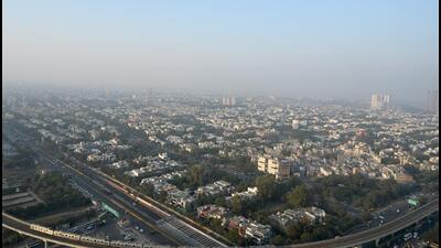 A Noida skyscraper engulfed in smog on Wednesday. The decision to shut schools for physical classes till January 1 has been taken in light of severe cold conditions in the district, said officials. (Sunl Ghosh/HT Photo)
