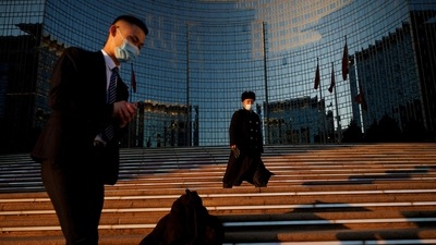 Covid In China: People wearing face masks walk on the steps of a luxury hotel in Beijing, (Reuters)