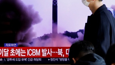 North Korea: A man walks past a TV broadcasting a news report, on North Korea firing a missile. (Reuters)