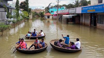 Residents of waterlogged Rainbow Drive Layout use coracles to commute after heavy monsoon rains at Sarjapur in Bengaluru on September 7, 2022. (PTI) Residents of waterlogged Rainbow Drive Layout use coracles to commute after heavy monsoon rains at Sarjapur in Bengaluru on September 7, 2022. (PTI)