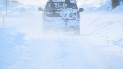 US Winter Storm: Vehicles drive through blowing snow following a winter storm. (Reuters)