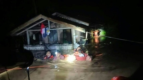 Philippine Coast Guard rescuers seen at work in Ozamiz City, Misamis Occidental on December 25. Sixteen of the 25 deaths were reported in Northern Mindanao region in the south, while 12 of the 26 missing are from the eastern Bicol region, AP reported. (Philippine Coast Guard / AFP)
