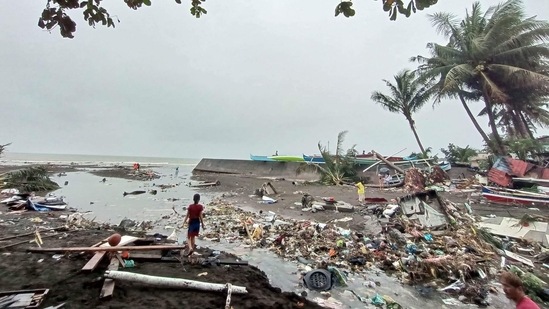 Residents survey damage caused by heavy rain and floods in Oroquieta City, Misamis Occidental, on December 27. As of December 28, the effect of the shear line has weakened, and a new low-pressure area may bring moderate to heavy rains within the next 24 hours to the same areas affected by the Christmas weekend floods, AP reported. (Angelica Villarta / AFP)