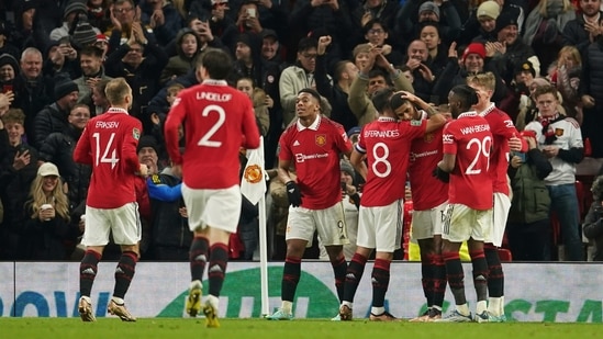 Manchester United's Marcus Rashford, third right, is mobbed by his teammates after scoring his sides second goal during the English League Cup 4th round soccer match between Manchester United and Burnley, at Old Trafford in Manchester, England Wednesday, Dec. 21, 2022. (AP Photo/Dave Thompson) (AP)