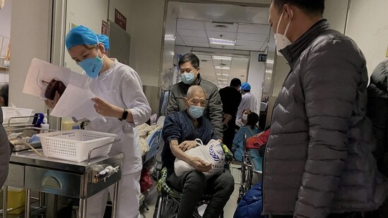 Covid In China: A Covid-19 patient being moved on a wheelchair at Tianjin First Center Hospital in Tianjin.(AFP)